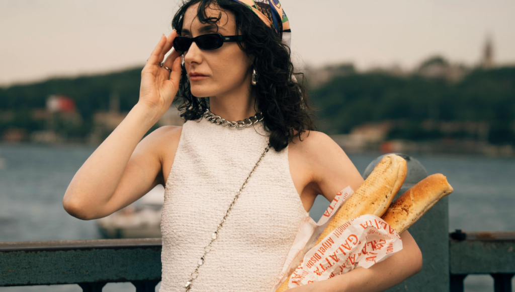 woman carrying French bread