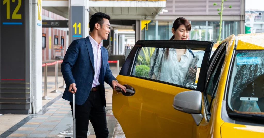 Man and woman entering a taxi